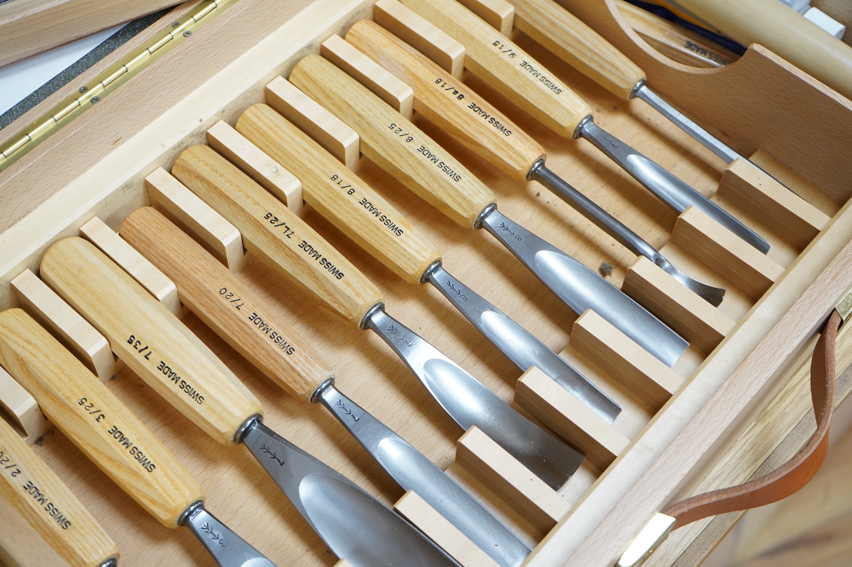 A Swiss made Pfeil 25-piece wood carving set, comprising; carving chisels, a mallet, sharpening stones, etc. contained within a fitted beech case, 530 x 330 x 95mm